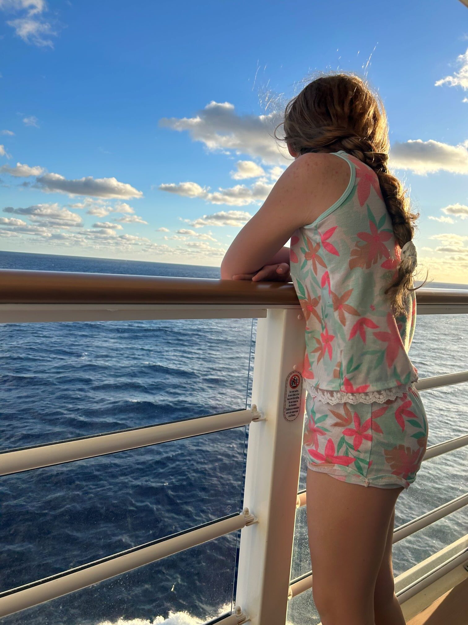 Child overlooking the ocean on cruise ship.