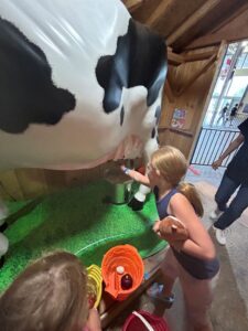girl milking cow at CNE.