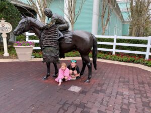 2 kids at Disney's Saratoga Springs by horse statue.