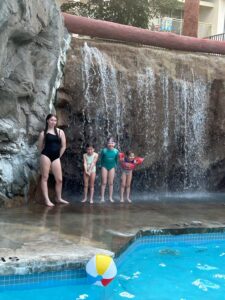 3 kids under waterfall at Lamplighter Inn, London