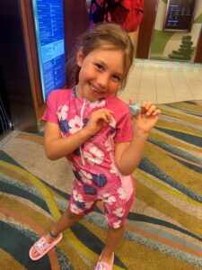 Child finding duck on cruise ship by elevator.