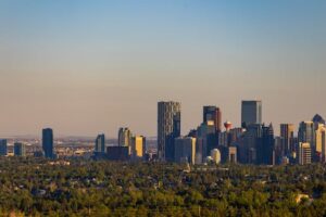 Stunning view of Calgary's skyline under a clear sky during sunrise, showing modern architecture.