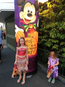 Child by banner of Mickey's Not So Scary Halloween Party.