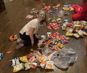 Child sorting halloween candy after trick or treating.