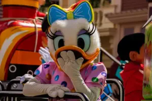 A vibrant character parade featuring a whimsical cartoon character in Chessy, France.