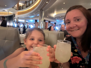 Mother and daughter drinking lemonade on cruise ship.