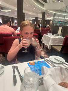 Child drinking chocolate milk on cruise.