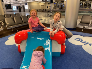Children playing at airport before flight.