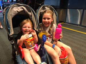2 kids in double stroller at Disney World.