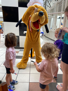 Pluto signing autograph book at disney world.
