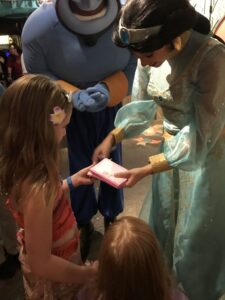 Children at Disney getting autographs